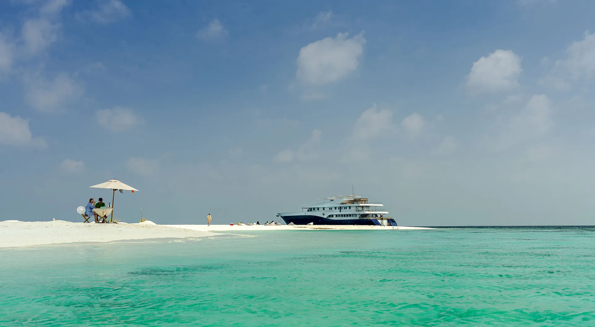 Guests enjoying the deck of a private charter yacht at sunset